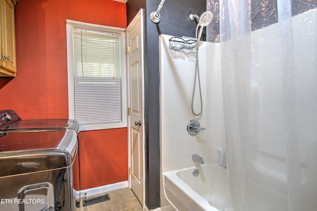 bathroom with tile patterned floors, shower / tub combo, and washing machine and clothes dryer