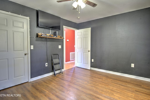 unfurnished bedroom featuring hardwood / wood-style floors and ceiling fan