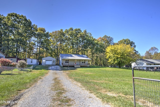 view of front of house featuring a garage, an outdoor structure, a porch, a front yard, and a carport