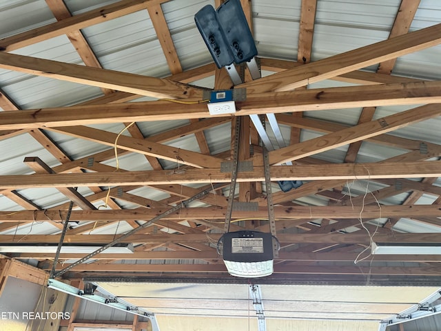 details with a garage door opener and beamed ceiling