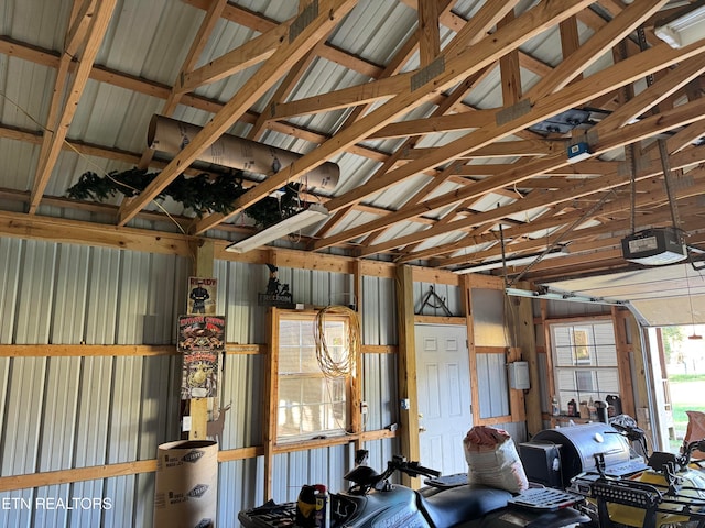 garage with a garage door opener and wooden walls