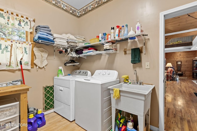 laundry room featuring light hardwood / wood-style flooring and washer and dryer