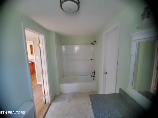 bathroom with tub / shower combination, toilet, and vanity