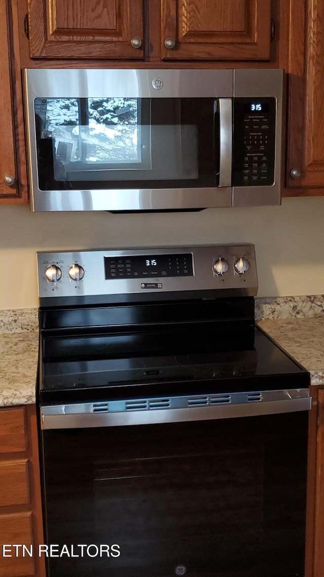 interior details featuring appliances with stainless steel finishes and brown cabinetry