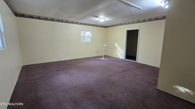 empty room with attic access and carpet