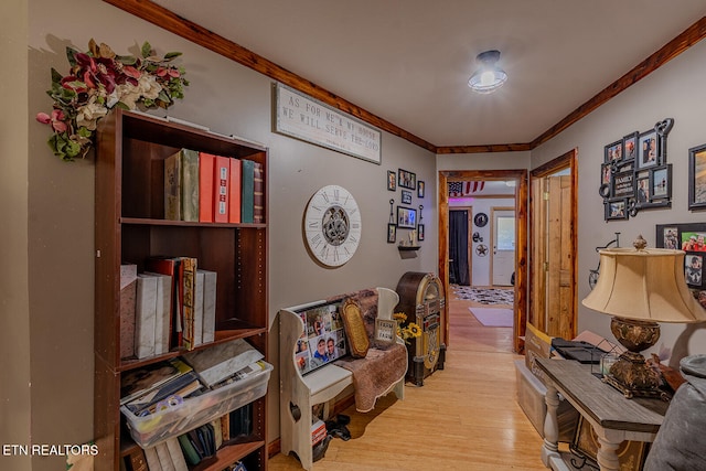 hall with crown molding and light hardwood / wood-style flooring