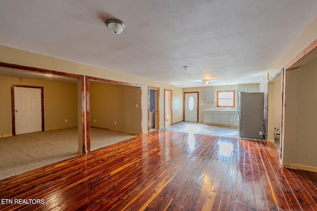 spare room featuring a textured ceiling and hardwood / wood-style flooring