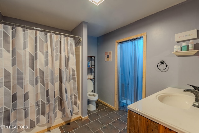 bathroom featuring vanity, toilet, and a shower with shower curtain