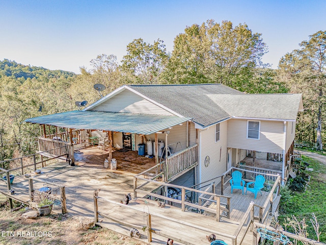 rear view of property featuring a wooden deck