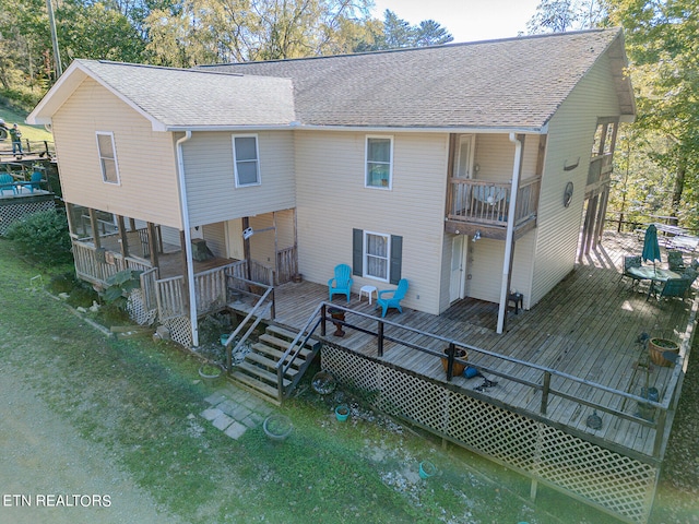 back of house featuring a deck