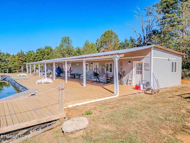 rear view of house with a yard and a deck