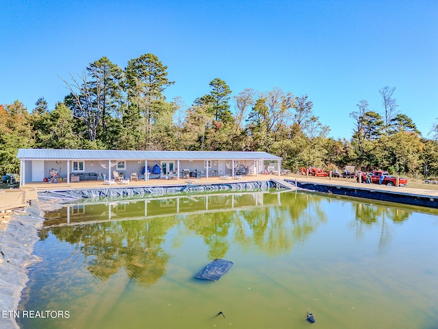 exterior space featuring a swimming pool and a water view