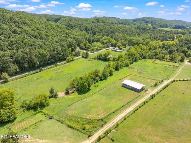 birds eye view of property with a rural view