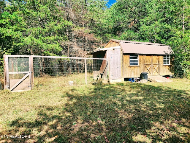 view of outbuilding with a lawn