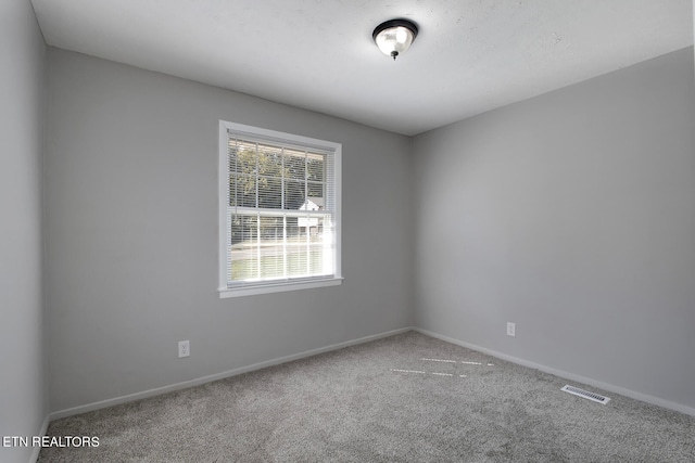 unfurnished room with carpet floors