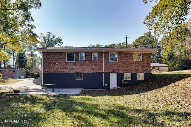 rear view of property with a yard and a patio