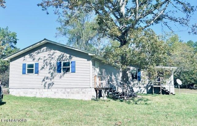 view of home's exterior with a yard