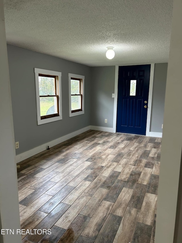 entrance foyer featuring hardwood / wood-style floors and a textured ceiling