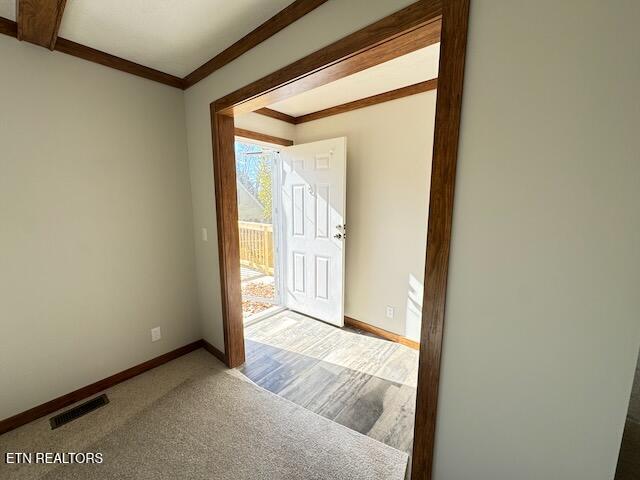 entryway featuring carpet and ornamental molding