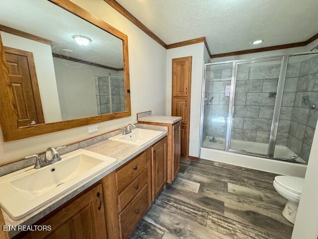 bathroom with vanity, crown molding, hardwood / wood-style floors, and toilet