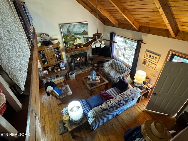 living room with lofted ceiling with beams, hardwood / wood-style flooring, wooden ceiling, and ceiling fan