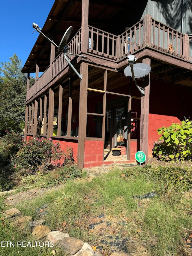 view of side of home with a deck