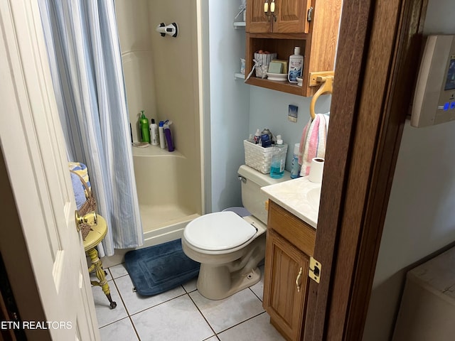 bathroom featuring tile patterned flooring, vanity, curtained shower, and toilet