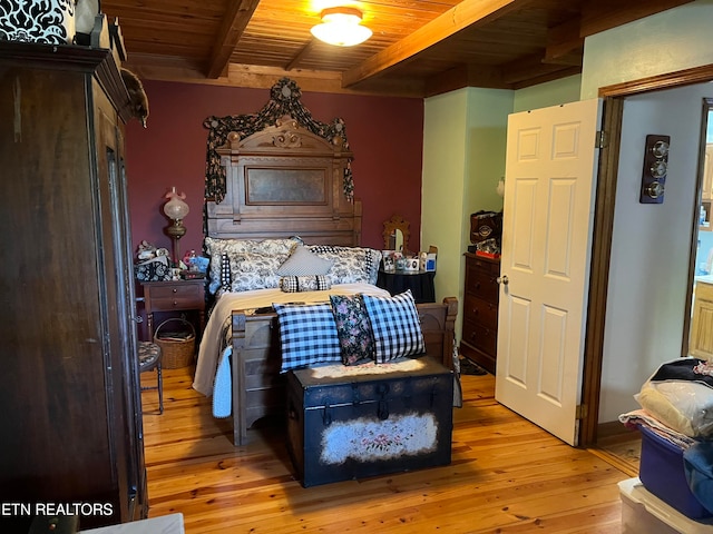 bedroom featuring wood ceiling, beamed ceiling, and light wood-type flooring