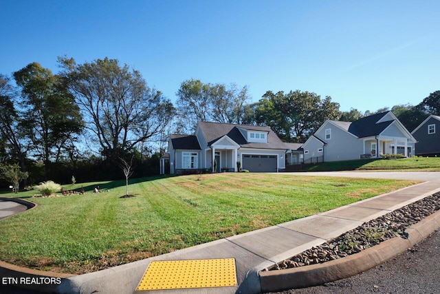 view of front of property featuring a front lawn and a garage