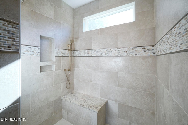 bathroom featuring a tile shower