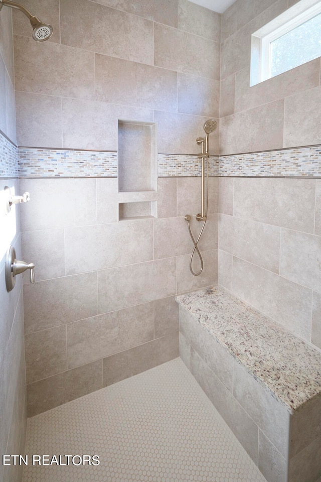 bathroom with a tile shower