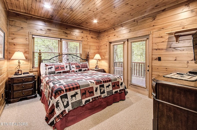 carpeted bedroom featuring access to outside, wood walls, recessed lighting, wooden ceiling, and multiple windows