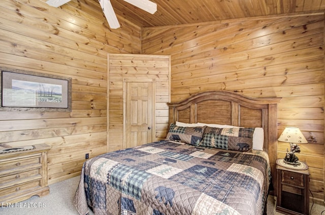 bedroom with carpet flooring, wooden ceiling, wood walls, and a ceiling fan