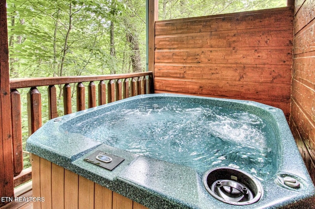 wooden deck featuring an outdoor hot tub