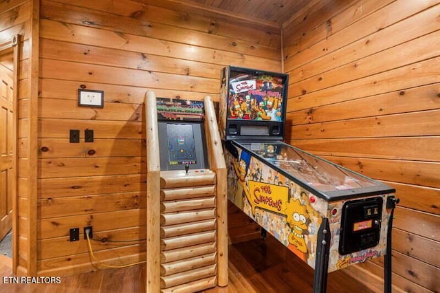game room featuring wood walls, wooden ceiling, and wood finished floors