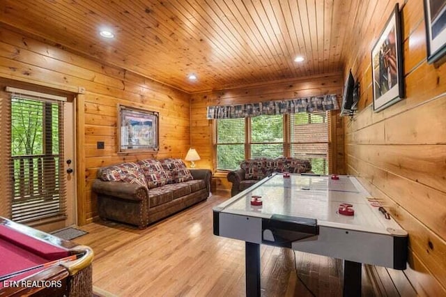 game room featuring wooden walls, wood ceiling, and plenty of natural light