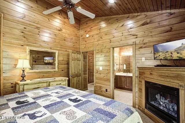 bedroom with wooden ceiling, wooden walls, a fireplace, and connected bathroom