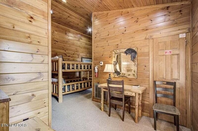 bedroom featuring carpet flooring, wood ceiling, and wooden walls