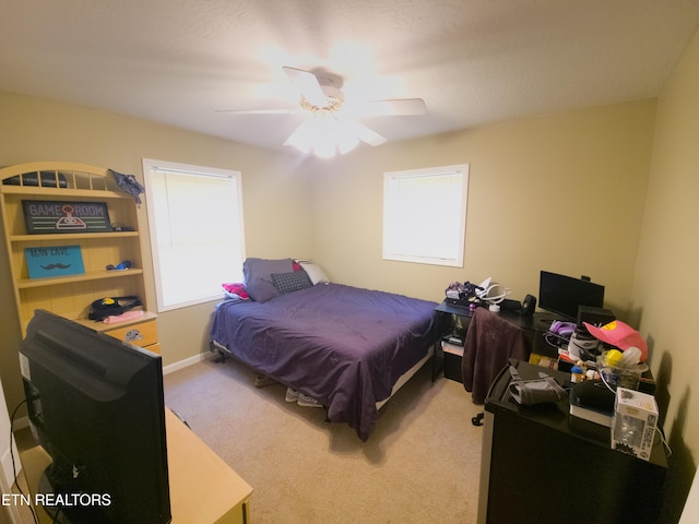 bedroom with multiple windows, carpet floors, and ceiling fan