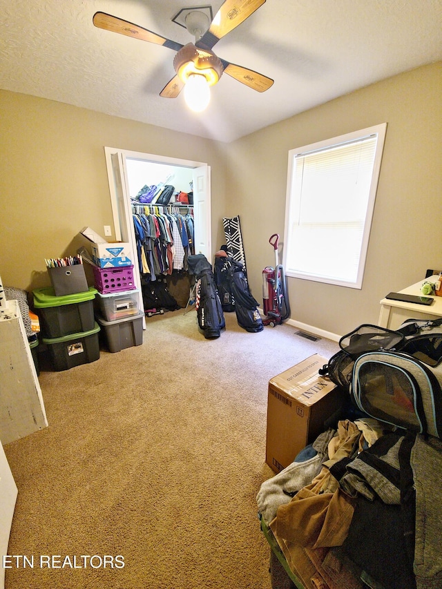 interior space with ceiling fan and carpet floors