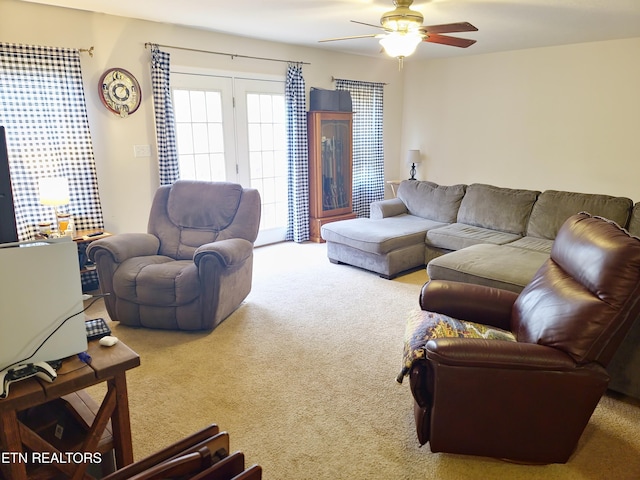 carpeted living room with ceiling fan