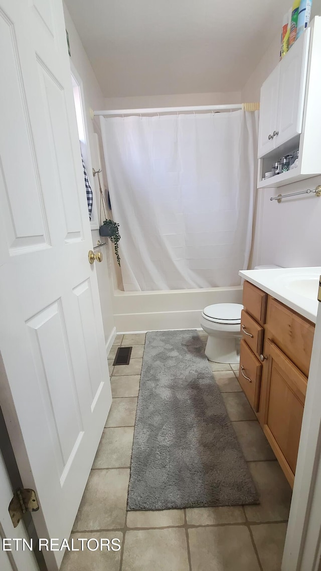 full bathroom featuring tile patterned flooring, shower / bath combo, toilet, and vanity