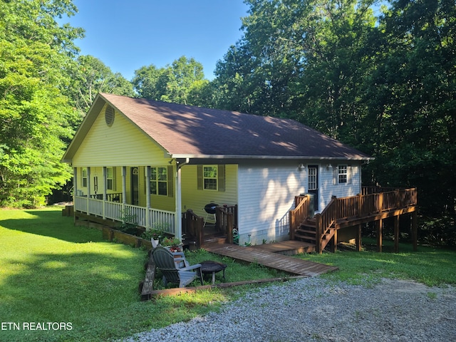 1149 Panther Branch Rd, Jamestown, TN 38556 - view of front of property with a front yard, roof with shingles, a porch, and a deck