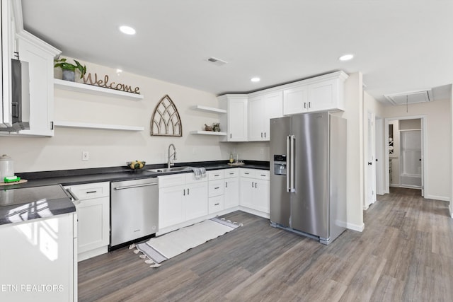 kitchen featuring dark wood-style flooring, a sink, open shelves, stainless steel appliances, and white cabinets