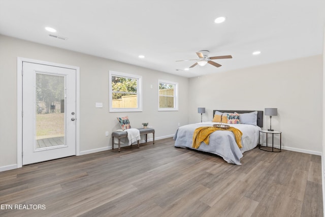 bedroom featuring visible vents, wood finished floors, access to outside, and recessed lighting