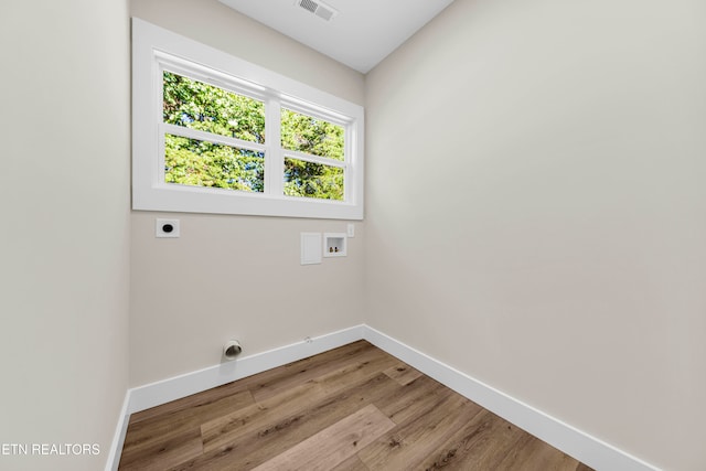 laundry area featuring hookup for a washing machine, light hardwood / wood-style floors, and hookup for an electric dryer