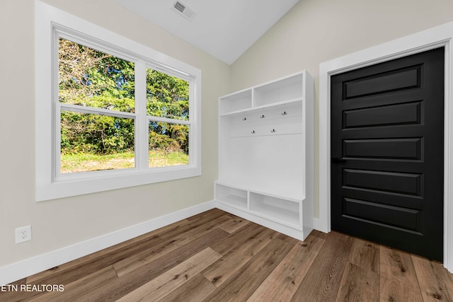 mudroom with wood-type flooring and vaulted ceiling