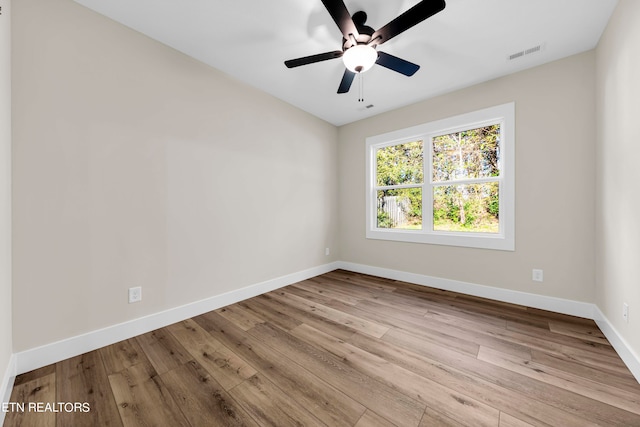 empty room featuring light wood-type flooring and ceiling fan