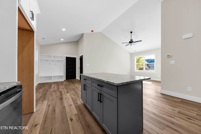 kitchen featuring black dishwasher, a kitchen island, light hardwood / wood-style floors, lofted ceiling, and gray cabinets