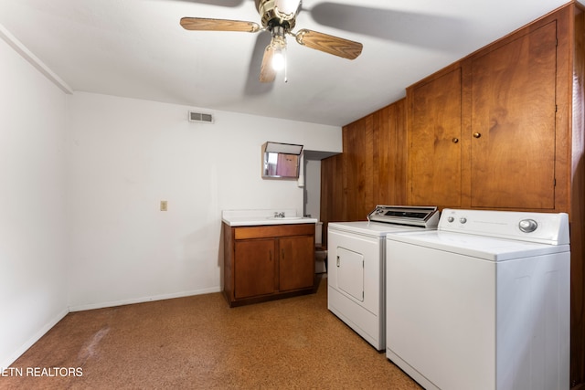 laundry room featuring washing machine and clothes dryer, ceiling fan, and cabinets